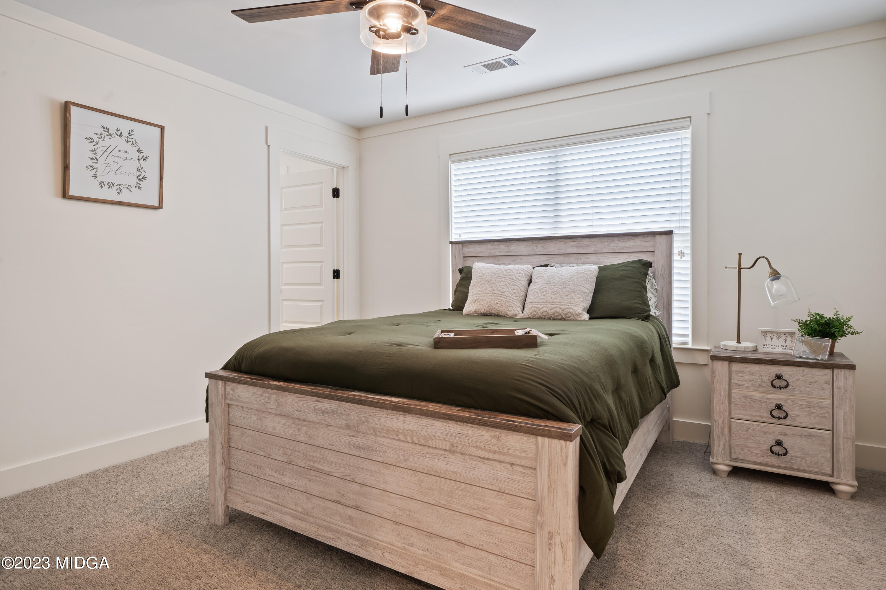 556 Pea Ridge Road Juliette, GA 31046 - Photo 24 of 42 a bedroom with a bed and a night stand