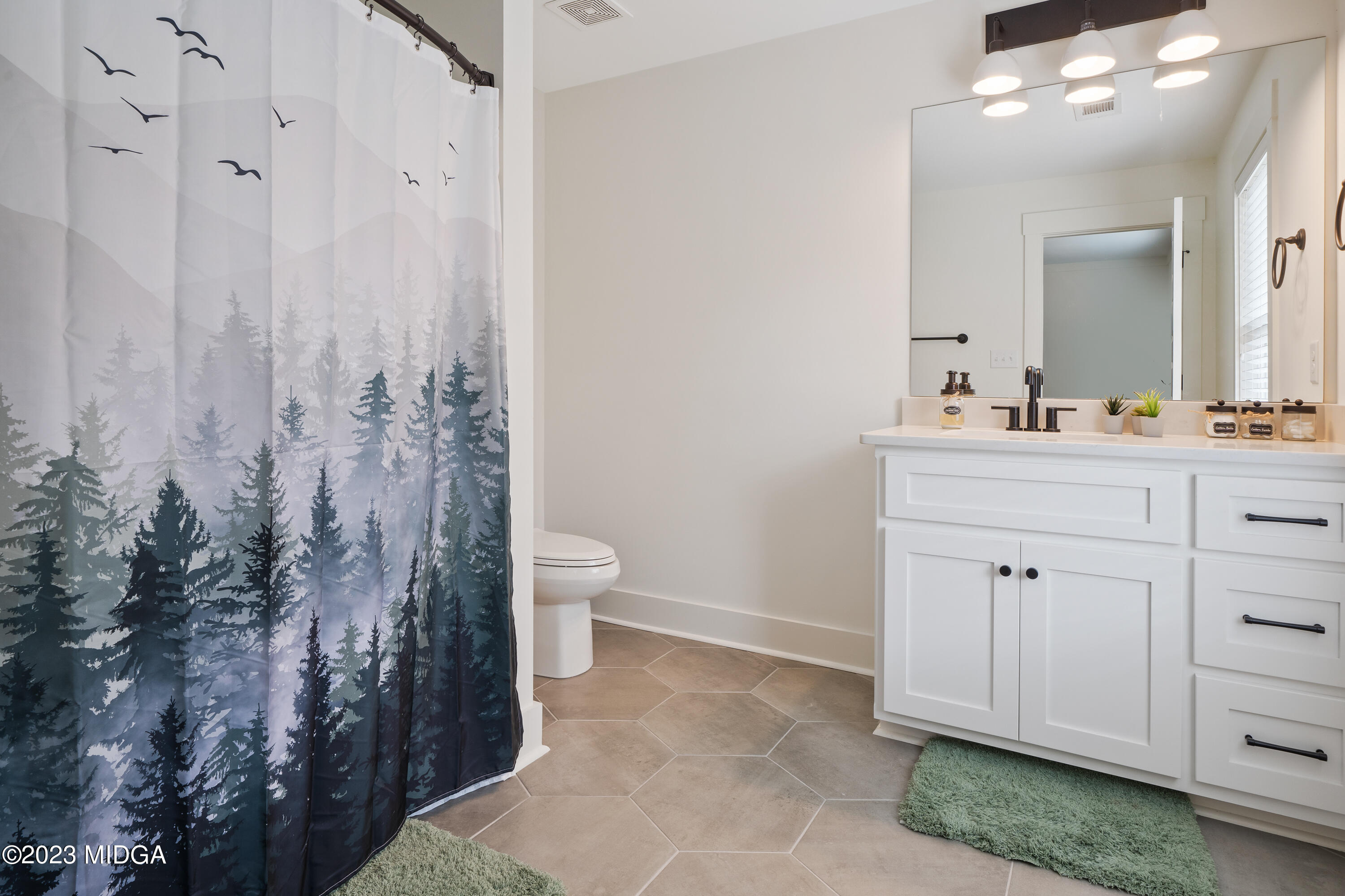 556 Pea Ridge Road Juliette, GA 31046 - Photo 25 of 42 a spacious bathroom with a toilet sink and mirror