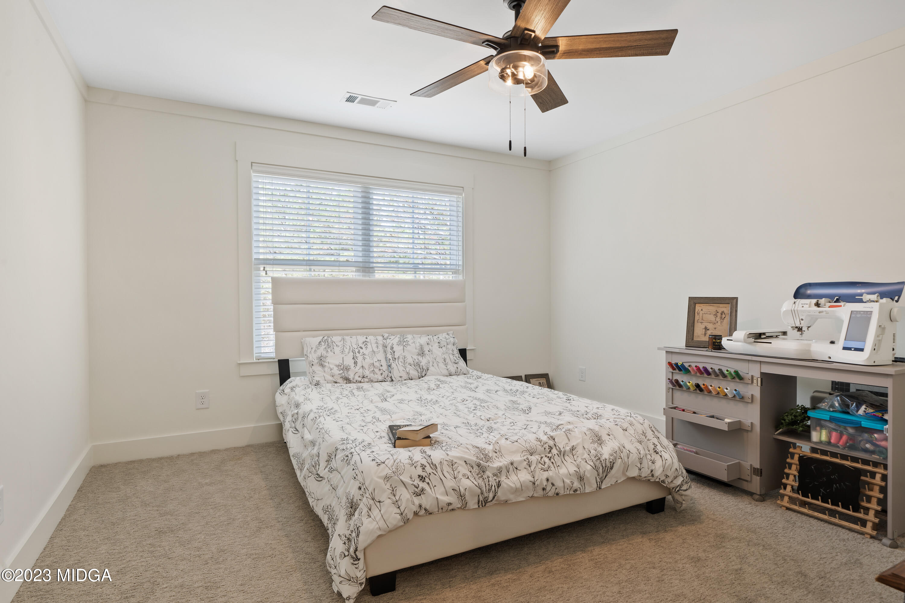 556 Pea Ridge Road Juliette, GA 31046 - Photo 28 of 42 a bedroom with a bed and a chandelier