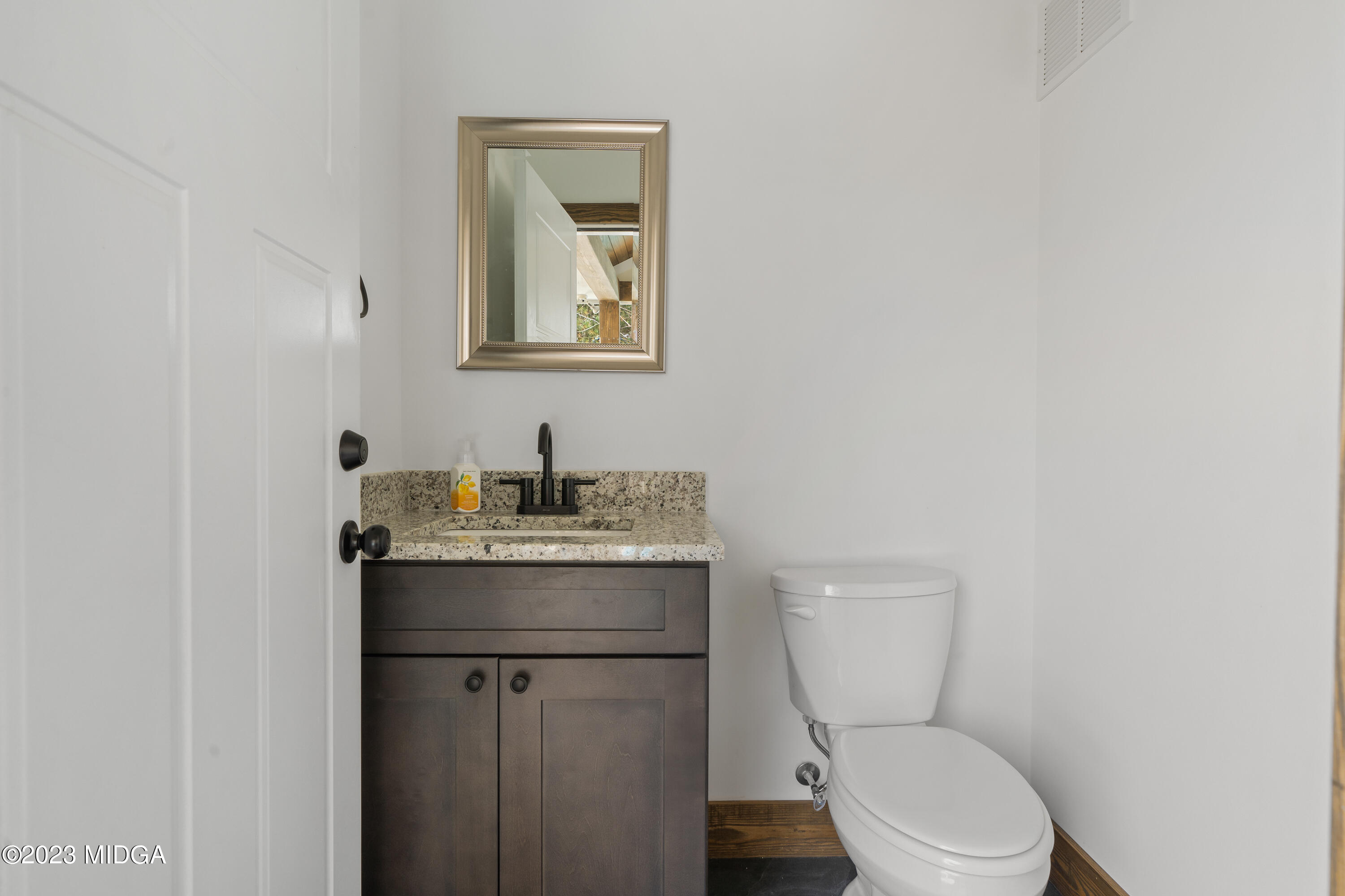556 Pea Ridge Road Juliette, GA 31046 - Photo 38 of 42 a bathroom with a toilet a sink and mirror