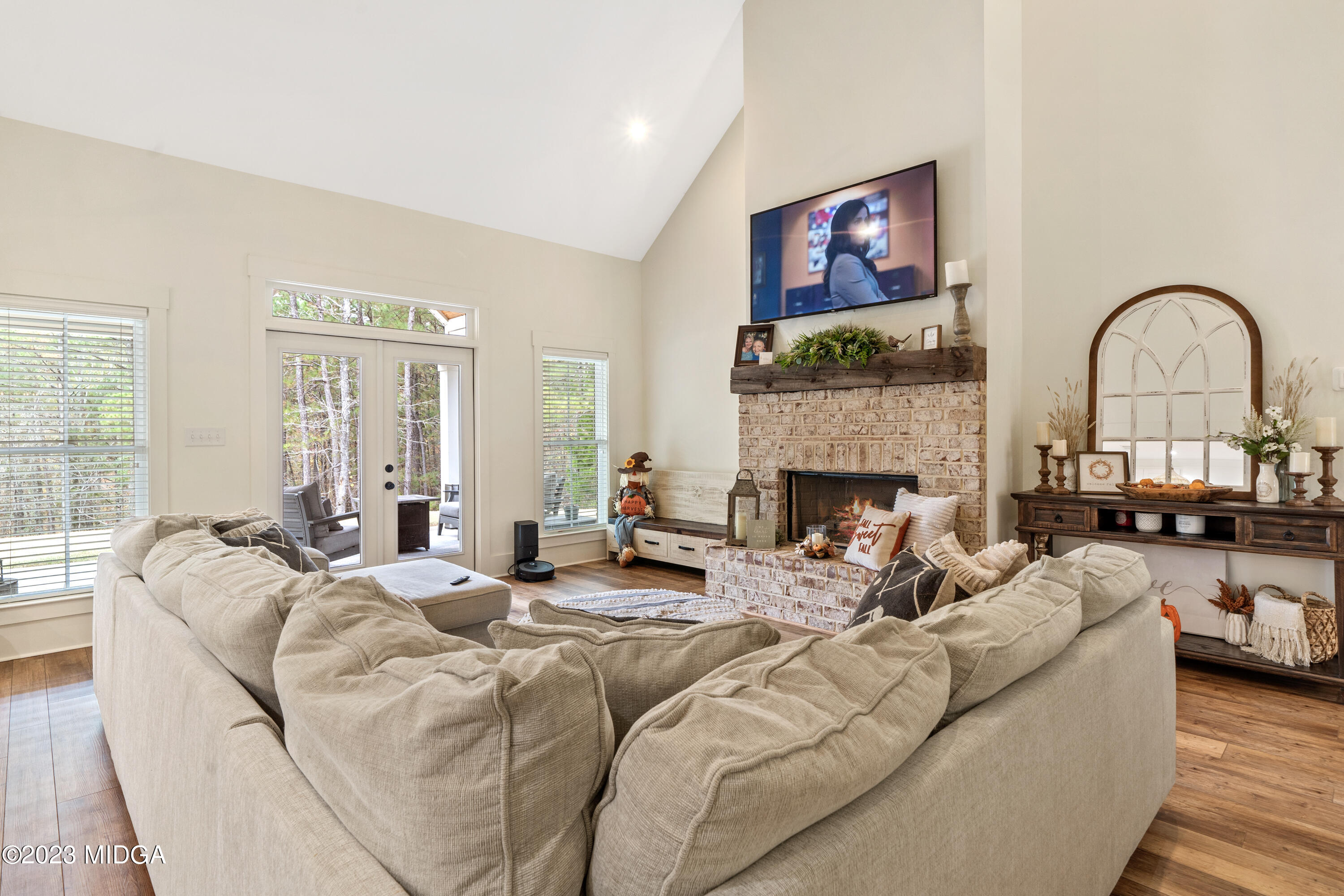 556 Pea Ridge Road Juliette, GA 31046 - Photo 10 of 42 a living room with furniture a fireplace and a large window