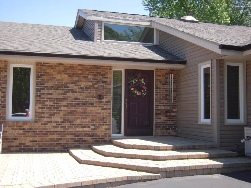 10409 Atwood Road Roscoe, IL 61073 - Photo 1 of 19 a front view of a house with a garage