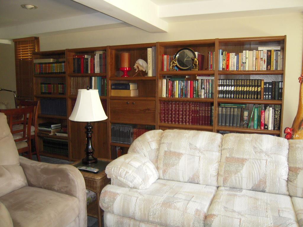 10409 Atwood Road Roscoe, IL 61073 - Photo 14 of 19 a living room with furniture a bookshelf and a book shelf