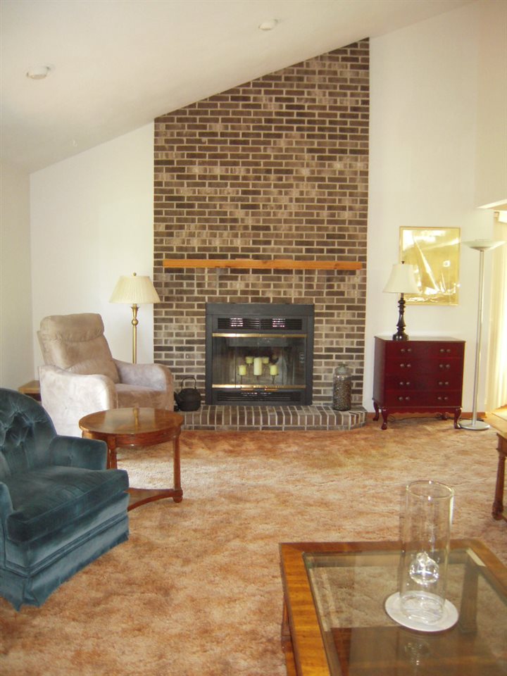 10409 Atwood Road Roscoe, IL 61073 - Photo 5 of 19 a living room with furniture and a fireplace