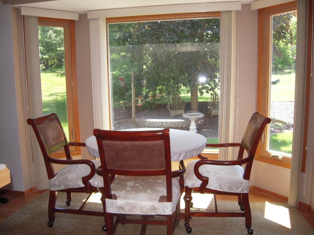 10409 Atwood Road Roscoe, IL 61073 - Photo 10 of 19 a dining room with furniture wooden floor and a potted plant