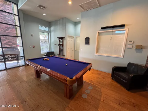 a room with pool table and windows