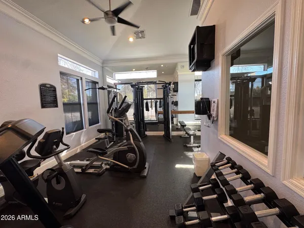a room with gym equipment and a large window
