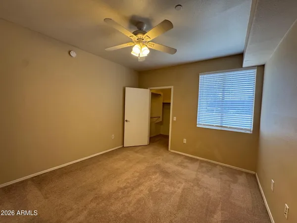 a view of an empty room with a ceiling fan
