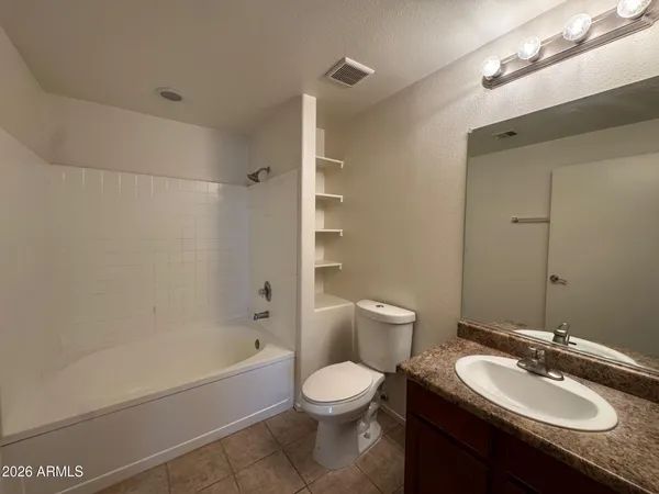 a bathroom with a sink toilet vanity and shower