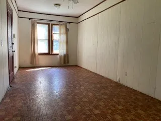 a view of kitchen with refrigerator cabinets and stove
