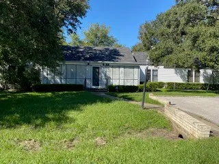 an empty room with wooden floor and a fireplace