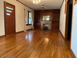 wooden floor in an empty room with a fireplace