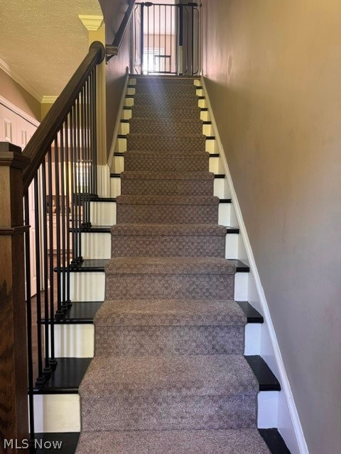 2760 Haines Road Madison, OH 44057 - Photo 7 of 33 Carpeted staircase featuring painted risers and dark wood-finish handrails with black metal balusters