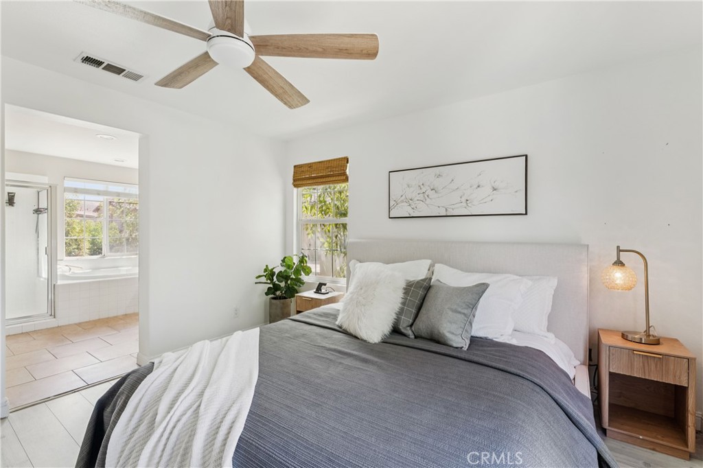 4155 Windspring Street Corona, CA 92883 - Photo 23 of 38 a bedroom with a bed and a chandelier