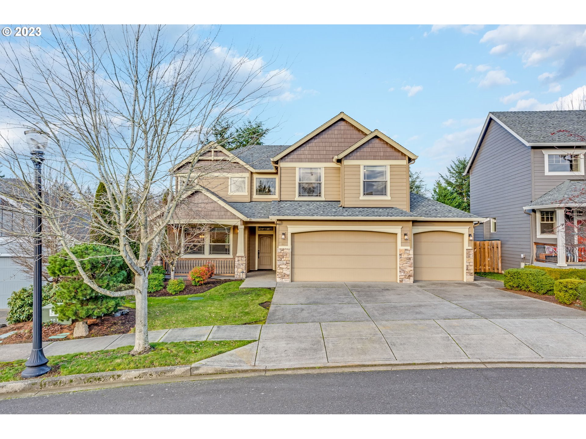 841 Northwest Sacajawea Place Camas, WA 98607 - Photo 1 of 48 a view of a yard in front of a brick house with large windows