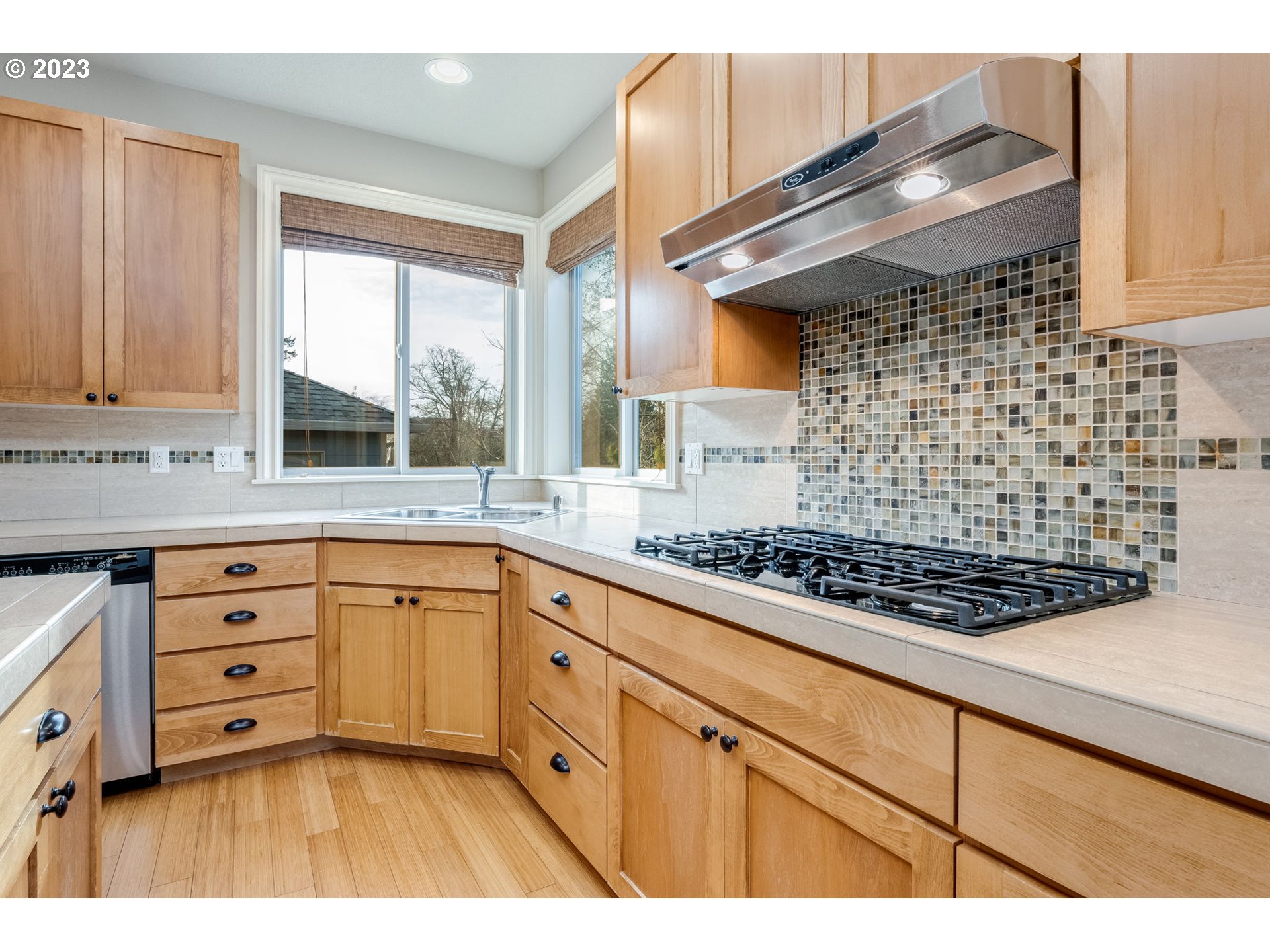 841 Northwest Sacajawea Place Camas, WA 98607 - Photo 13 of 48 a kitchen with stainless steel appliances a stove a sink a cabinets and wooden floor