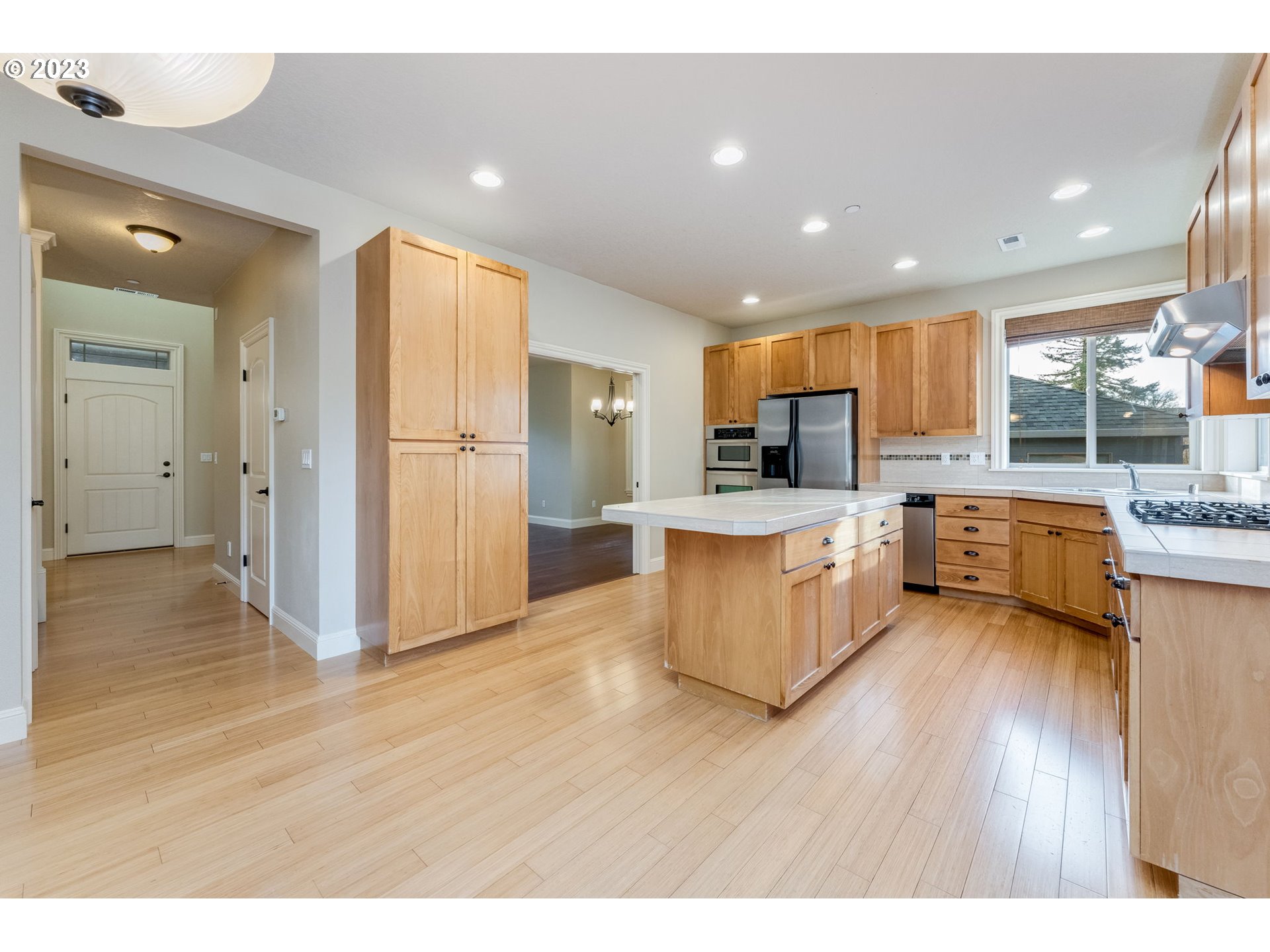 841 Northwest Sacajawea Place Camas, WA 98607 - Photo 19 of 48 a open kitchen with a refrigerator and a stove top oven