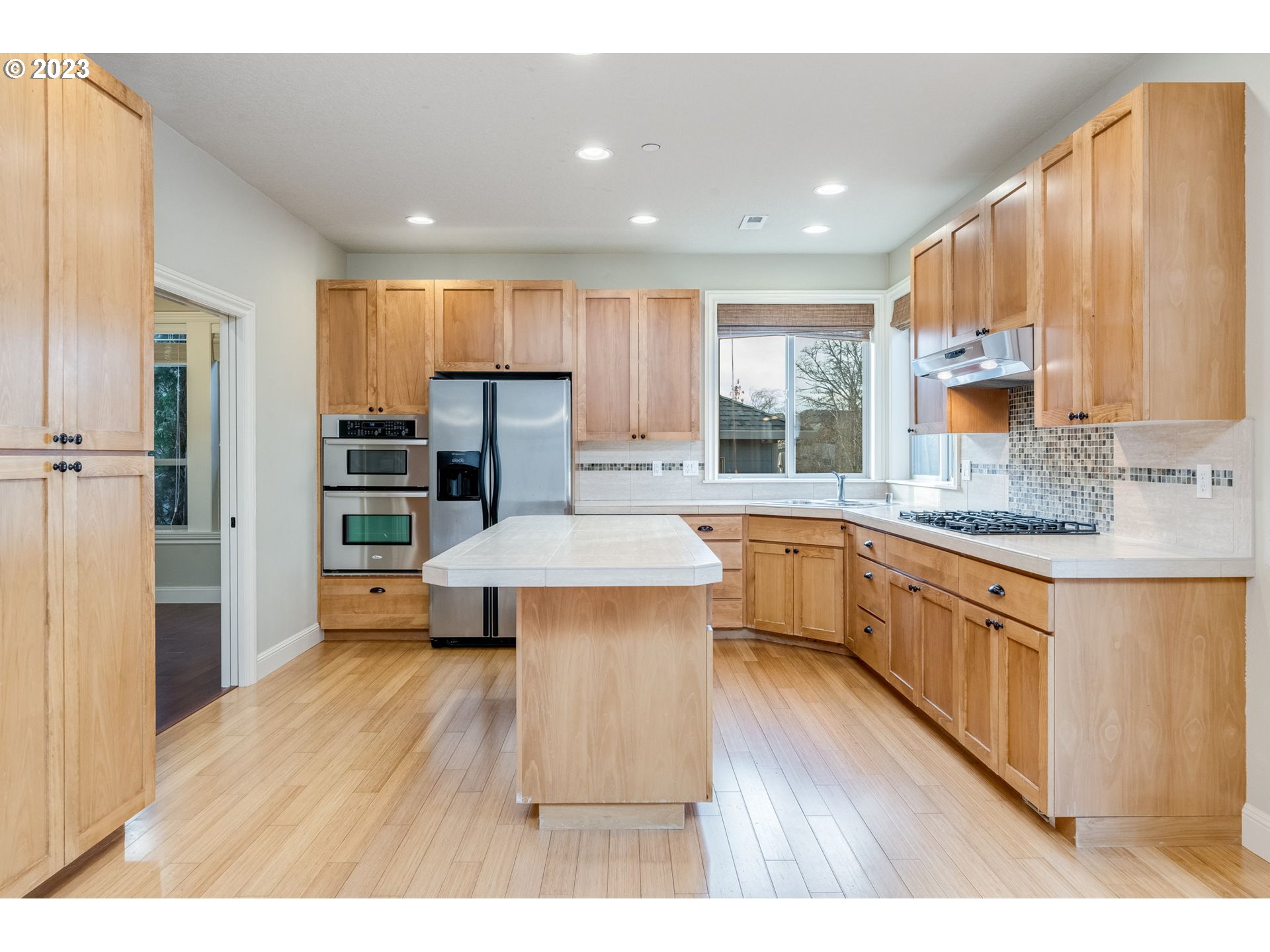 841 Northwest Sacajawea Place Camas, WA 98607 - Photo 10 of 48 a kitchen with stainless steel appliances wooden floors and wooden cabinets