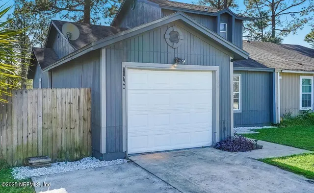 a front view of a house with a wooden fence