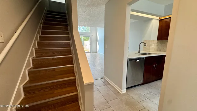 a view of an entryway with wooden floor and cabinets