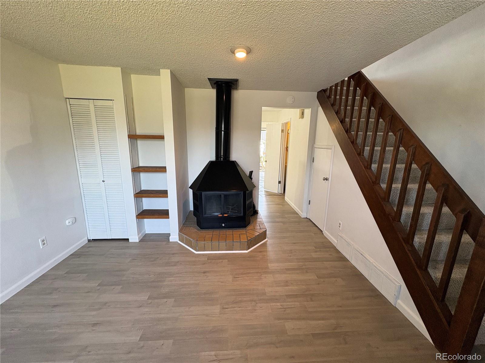 5505 Mansfield Court Colorado Springs, CO 80918 - Photo 2 of 14 a view of a livingroom with wooden floor and stairs