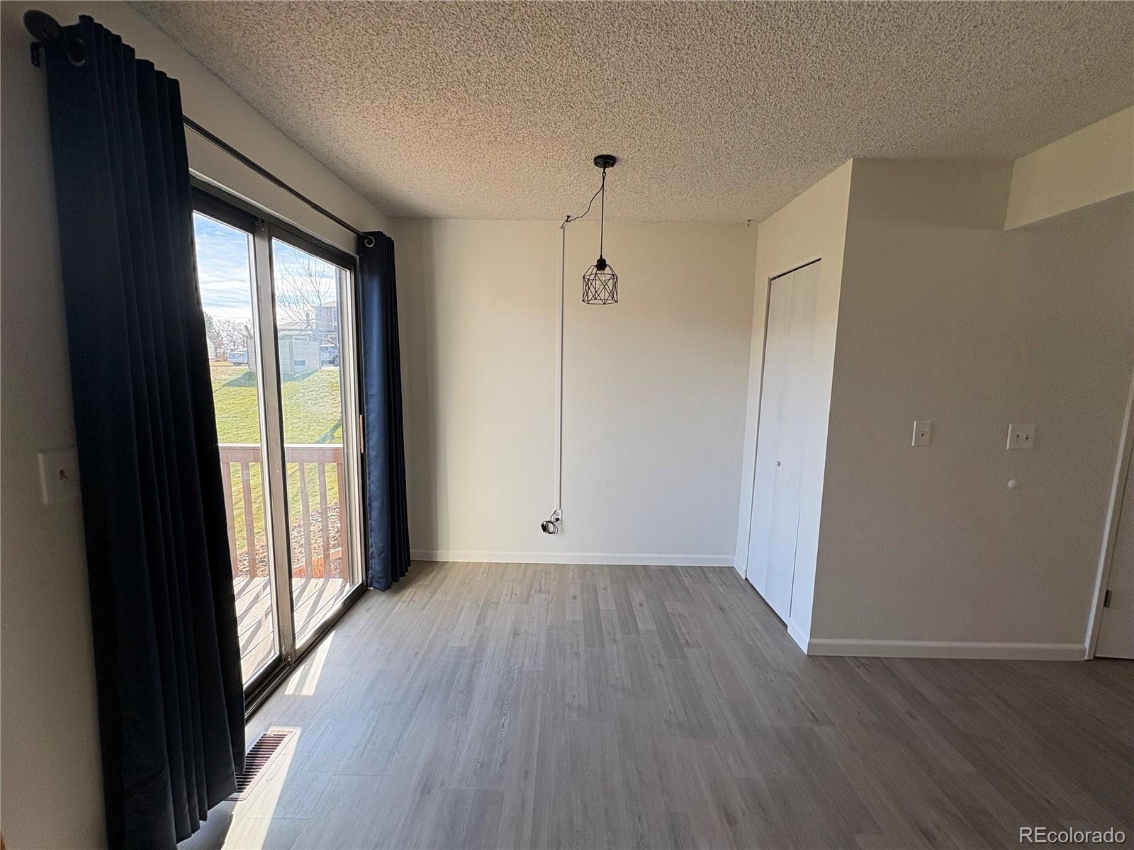 5505 Mansfield Court Colorado Springs, CO 80918 - Photo 7 of 14 wooden floor in an empty room with a window