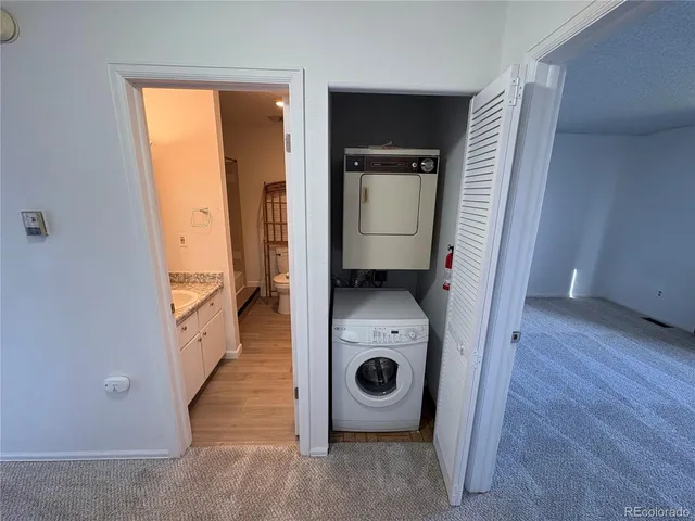 a view of a storage and utility room with a washer and dryer