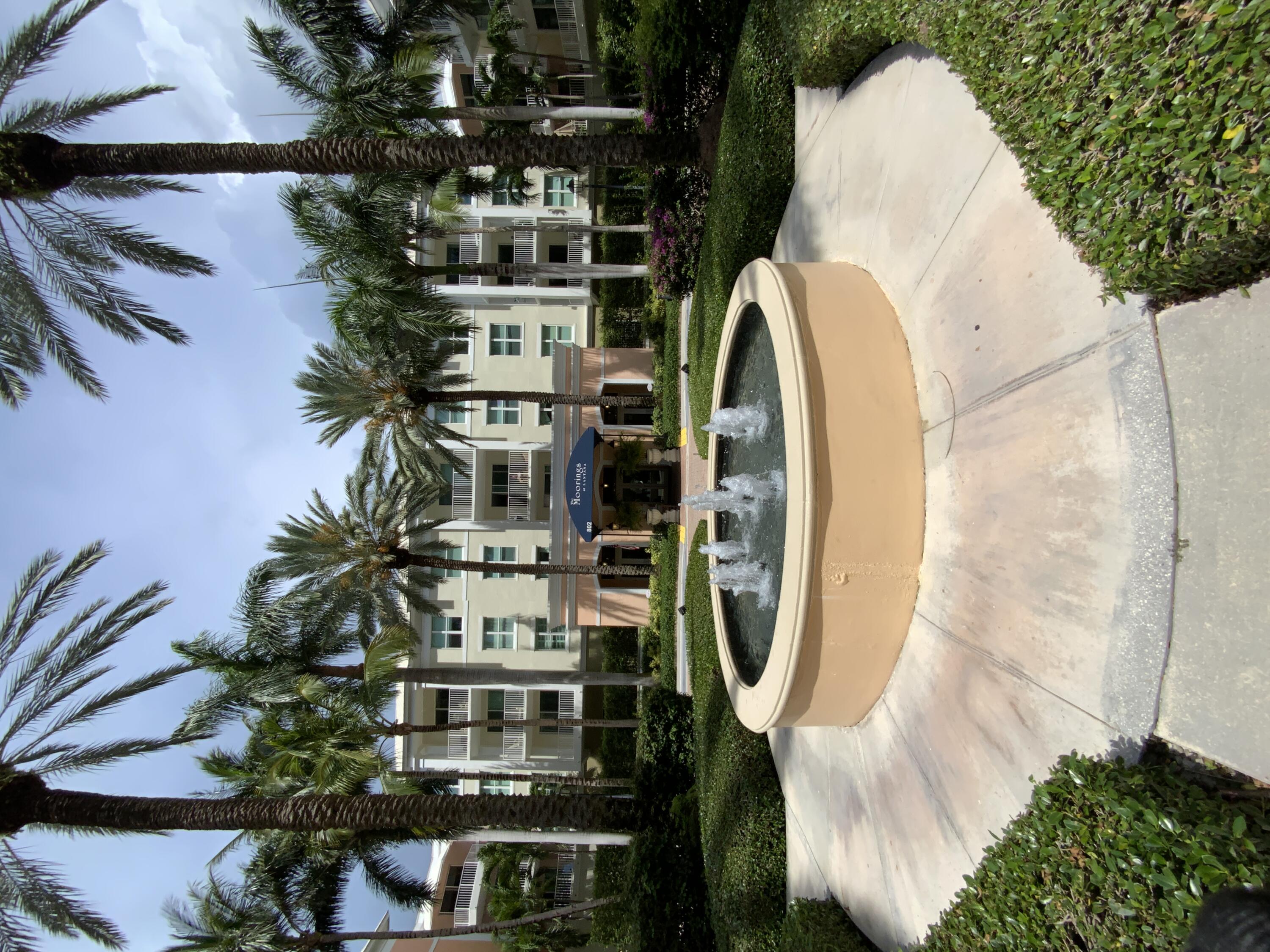 a view of a fountain in front of a house