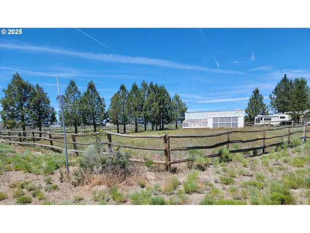 a backyard of a house with a yard and outdoor seating