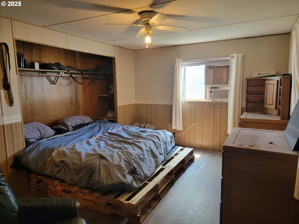 a bedroom with a bed and a flat tv screen