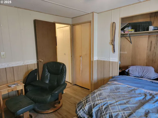 a bedroom with a bed and chair