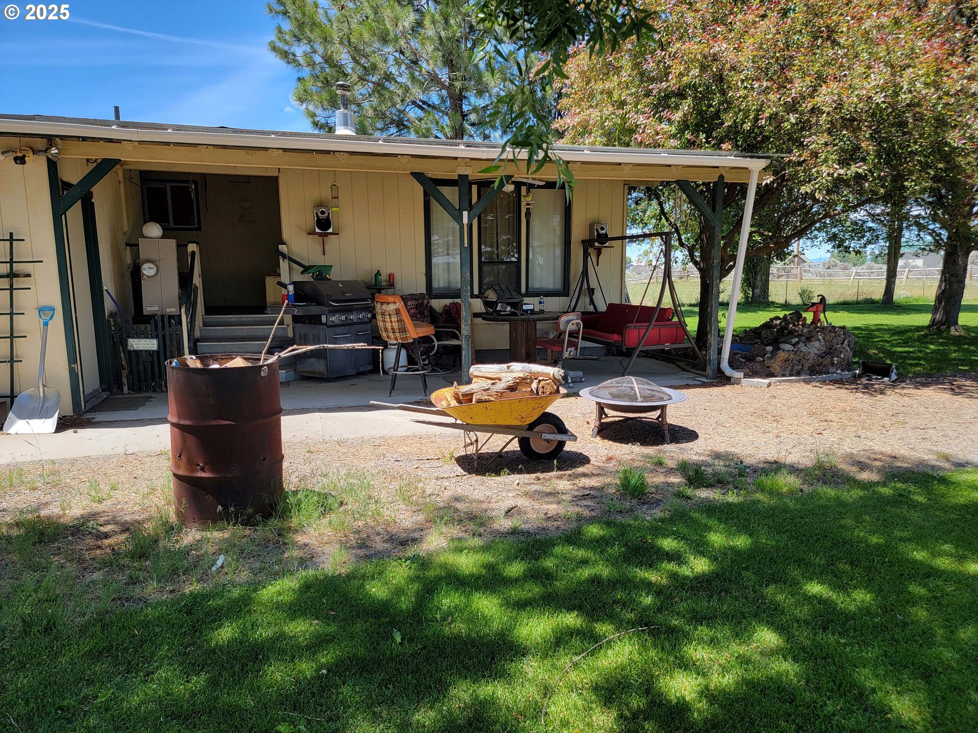 57580 Fall Road Christmas Valley, OR 97641 - Photo 26 of 38 a view of a patio with table and chairs under an umbrella