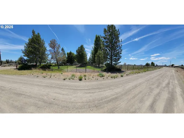 a building outdoor space with patio furniture and garden