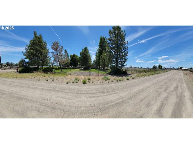 a building outdoor space with patio furniture and garden