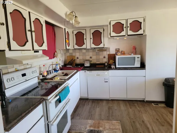 a kitchen with stainless steel appliances granite countertop a stove and a sink