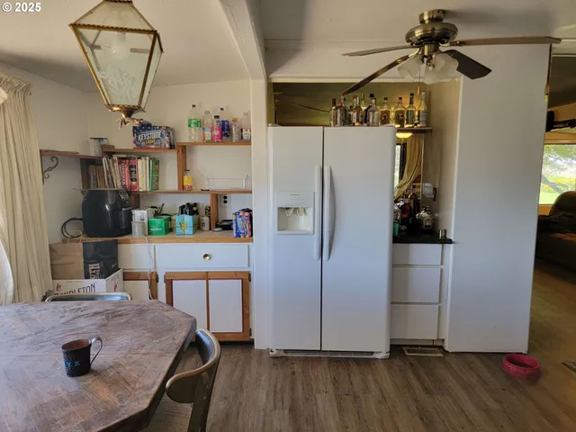 a kitchen with stainless steel appliances a refrigerator and a stove top oven