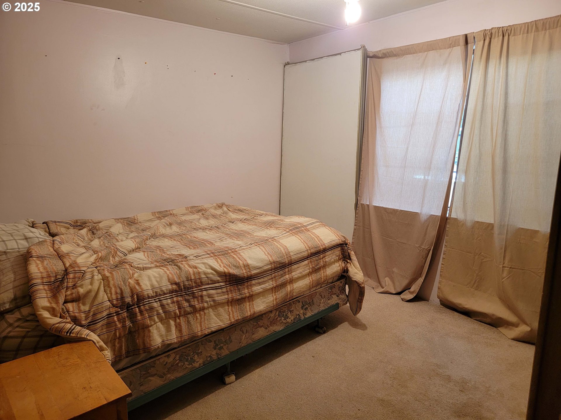 57580 Fall Road Christmas Valley, OR 97641 - Photo 10 of 38 a bed sitting in a room next to a shower curtain