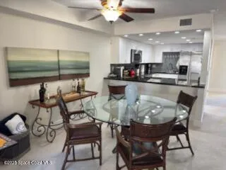 a kitchen with a dining table chairs and white cabinets