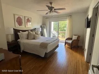 a bedroom with a bed couch and a large window