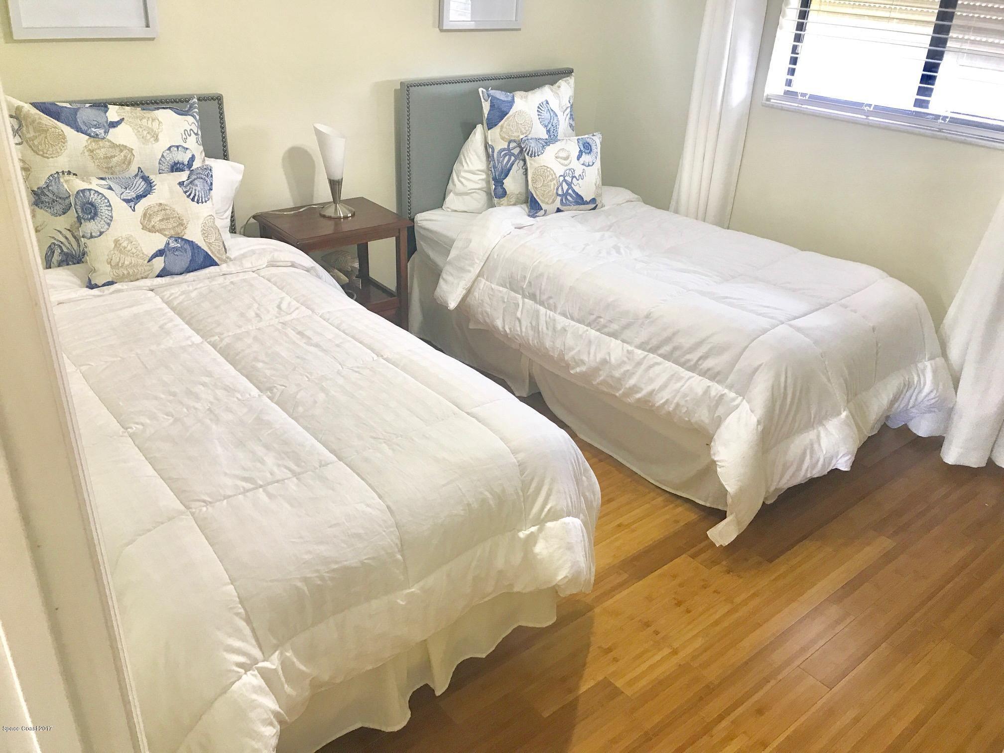 3245 Beach View Way Melbourne Beach, FL 32951 - Photo 10 of 21 a large white bed in a white room