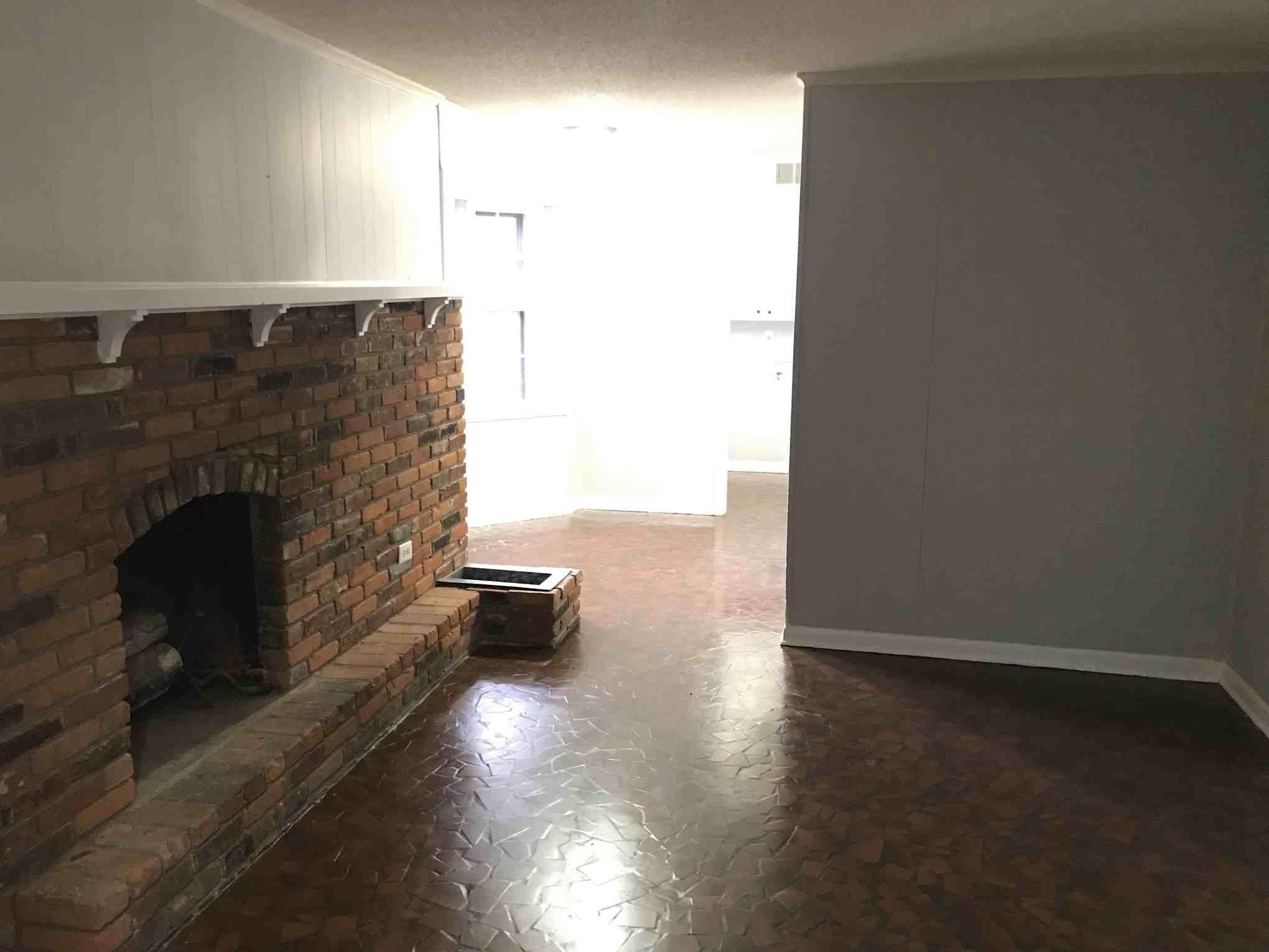 4502 Cottonwood Road Memphis, TN 38118 - Photo 4 of 16 Brick fireplace with a substantial hearth and mantel, featuring an interior wood-burning area