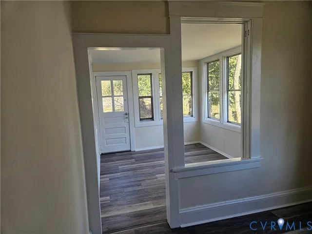 a view of an entryway with wooden floor