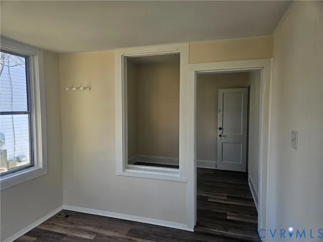 a view of a hallway with wooden floor and closet