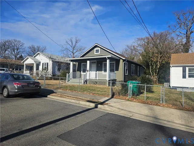 a front view of a house with a garden and parking space