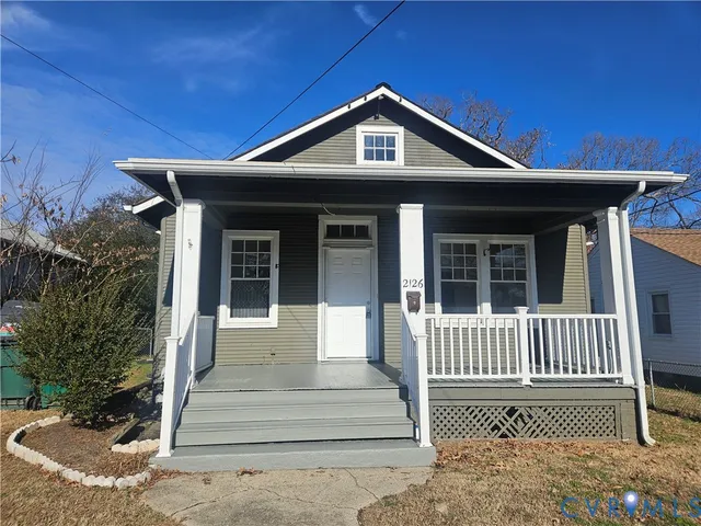a front view of a house with wooden fence