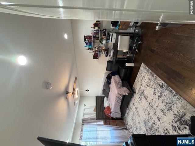 177 Maple Street Fairview, NJ 07022 - Photo 10 of 24 a bedroom with furniture and a chandelier