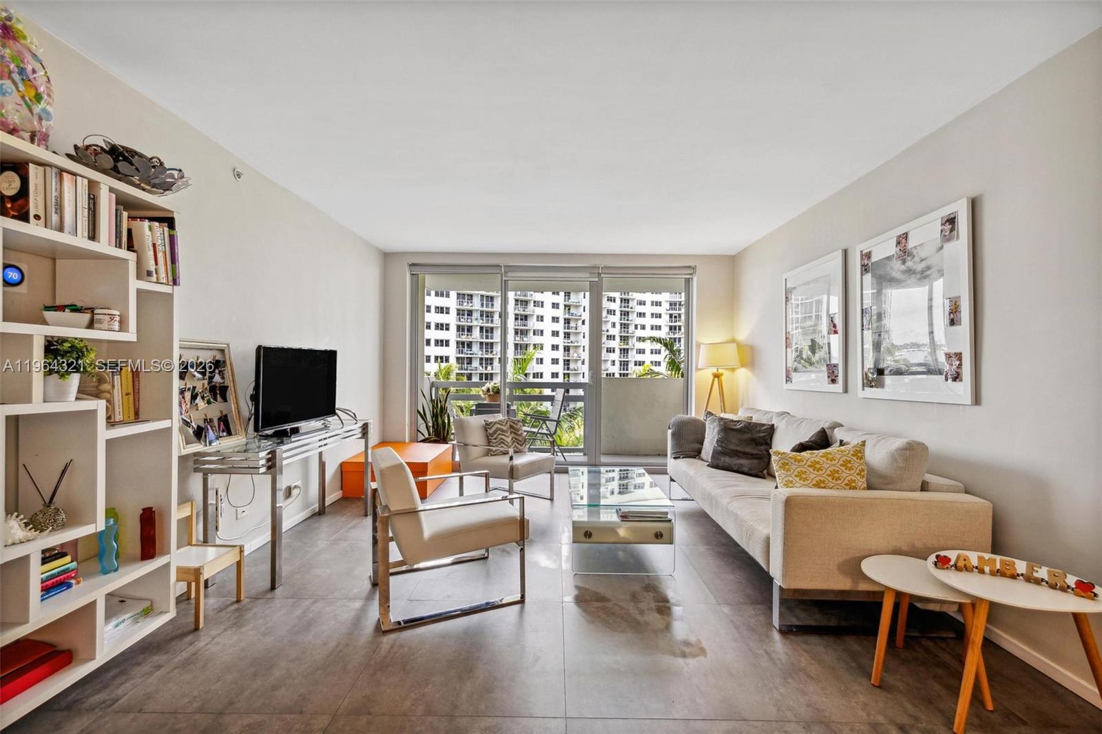 1500 Bay Road, Unit 544S Miami Beach, FL 33139 - Photo 3 of 32 a living room with furniture a flat screen tv and a window