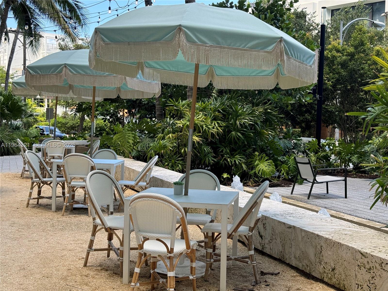 1500 Bay Road, Unit 544S Miami Beach, FL 33139 - Photo 32 of 32 a patio with table and chairs under an umbrella