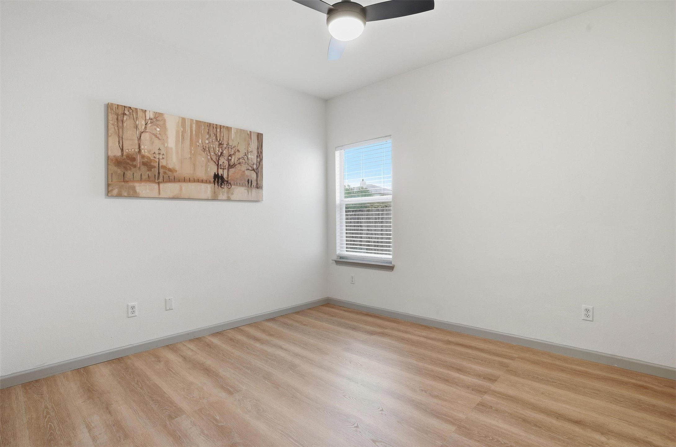 11606 Murchison Street Manor, TX 78653 - Photo 23 of 35 This room features light wood-look flooring, a window with blinds, and a ceiling fan