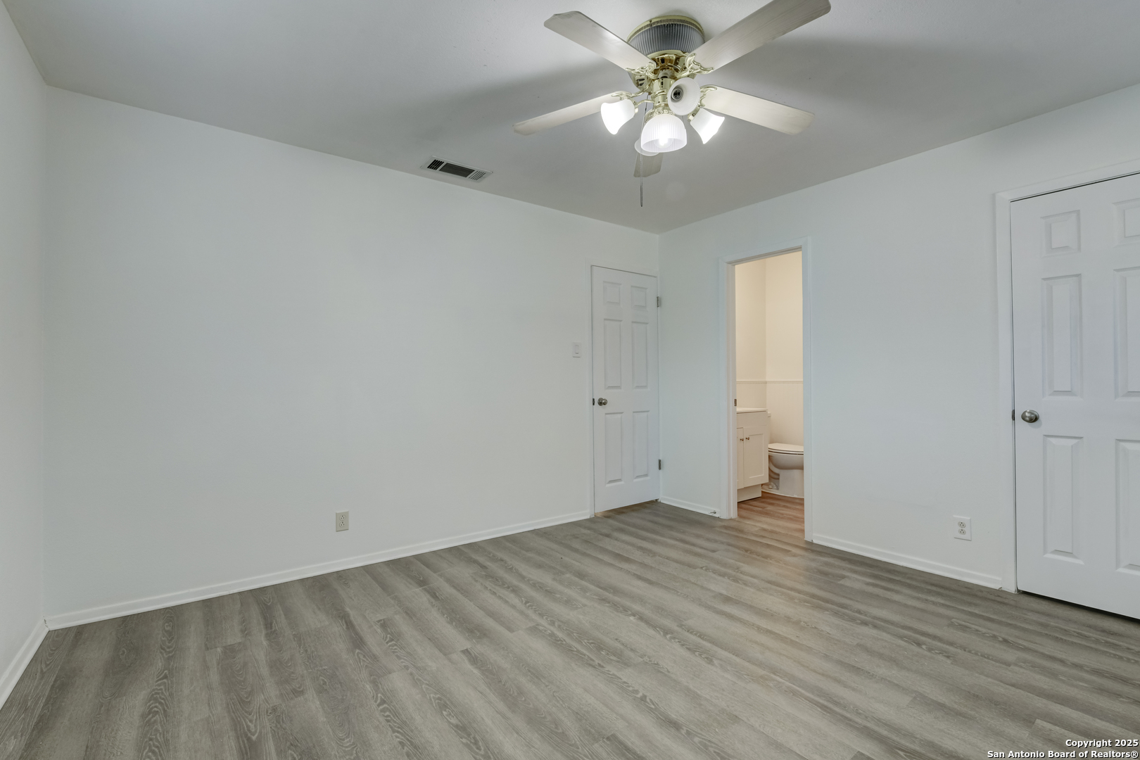 1044 Richmond Drive Schertz, TX 78154 - Photo 11 of 23 an empty room with wooden floor and ceiling fan
